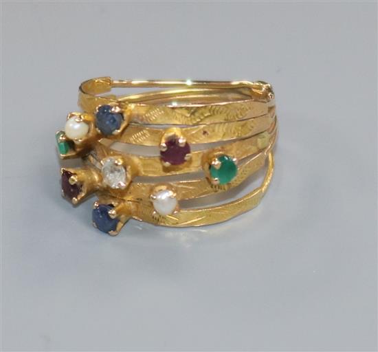 A yellow metal and multi gem set multi shank ring (a.f.), size H.